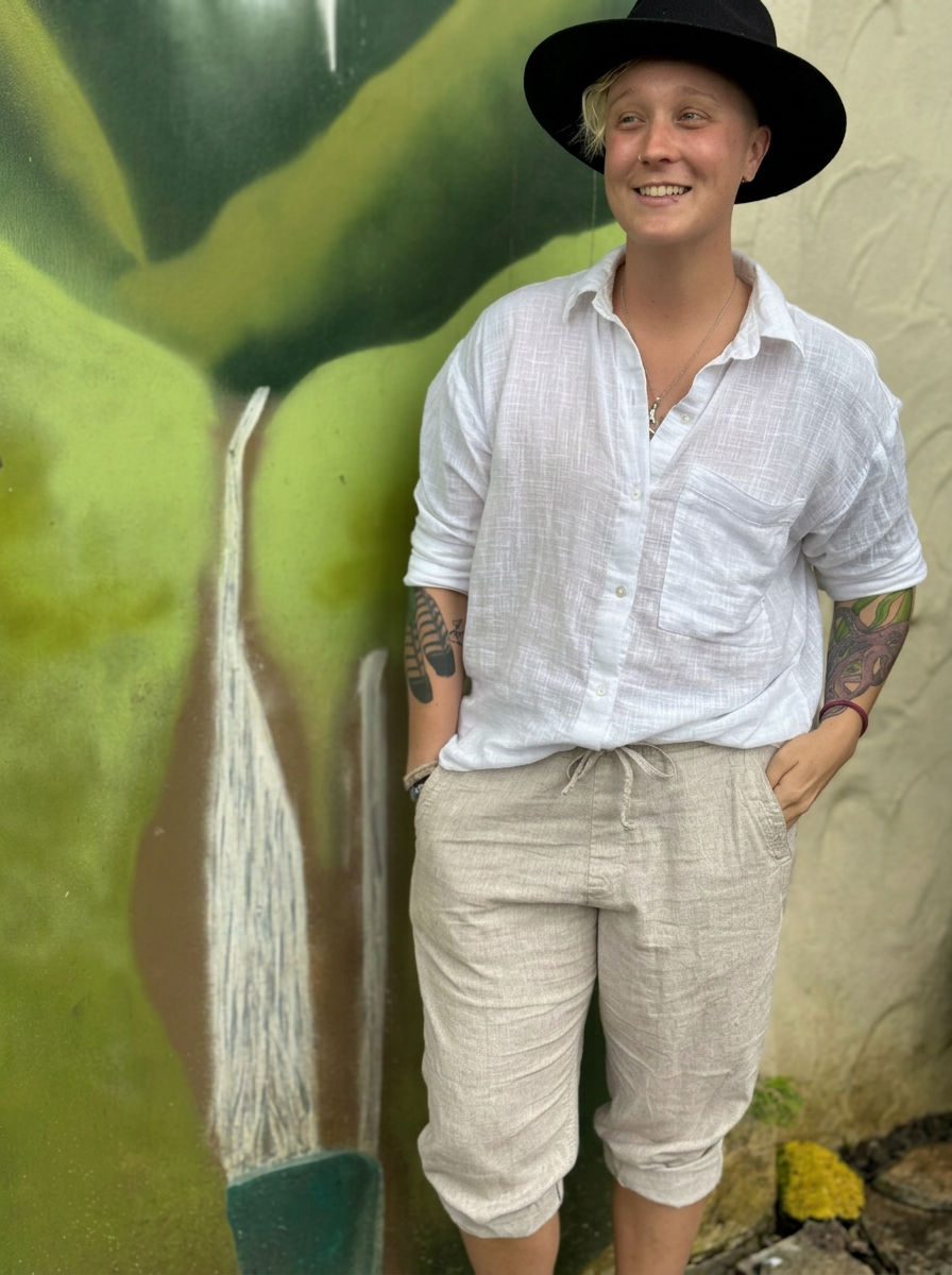 Jules Marsh in a black hat and white linen shirt